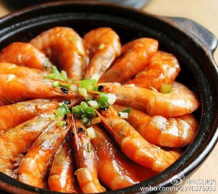 将虾码到铺有生姜及大蒜的砂锅内4.