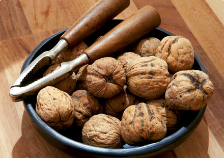 bowl of walnuts with nut cracker