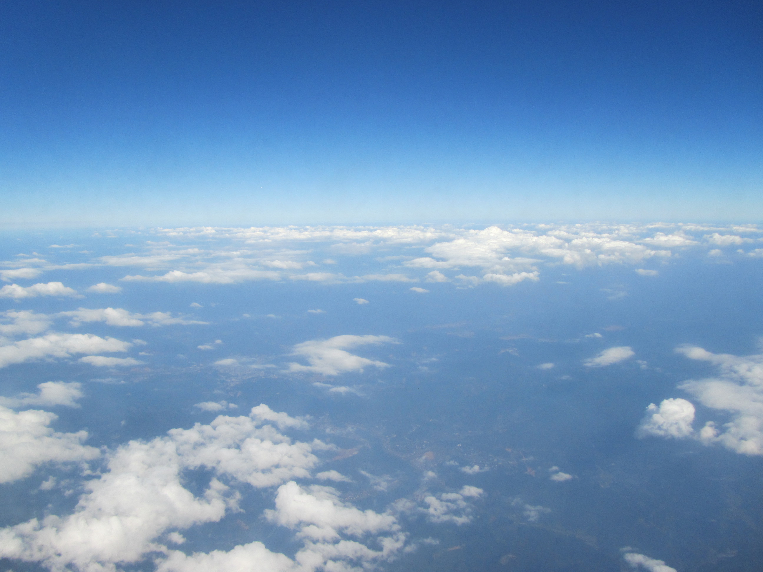 蓝蓝的天空,云块轻轻地碰撞着,缓慢而又柔和地漂浮,远处银白色的天空